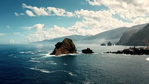 Dramatic ocean waves crash against rocky island cliffs scenic coastal panoram Stock Footage 341068005