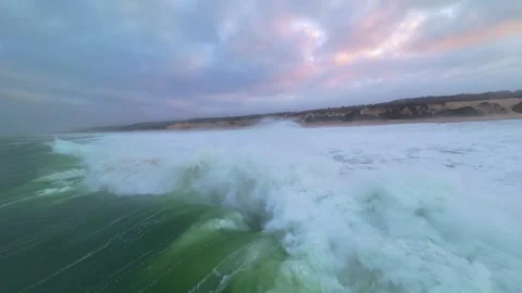 Dramatic ocean waves crash on beach at dawn Stock Footage 345148806