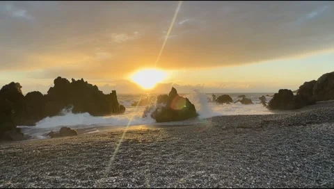 Dramatic Ocean Waves Crashing Against Rocky Shore at Sunset Stock Footage 303407673