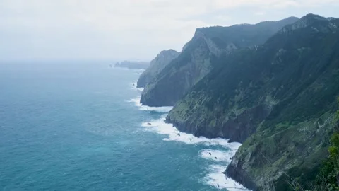 Dramatic ocean waves crashing against a rugged and steep coastline Vídeo Stock 333695918