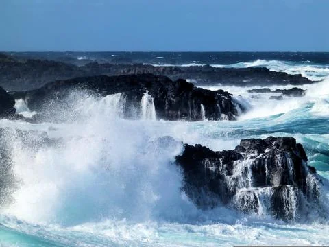 Dramatic Ocean Waves Crashing Against Rocky Shoreline Stock Photos