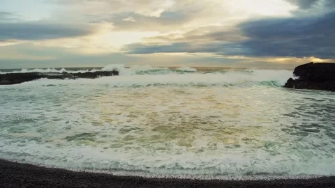Dramatic Ocean Waves Crashing on a Black Sand Beach in Iceland at Sunset Stock Footage 320202155
