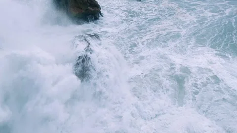 Dramatic Ocean Waves Crashing Powerfully Against Jagged Coastal Rocks Stock Footage 297468751