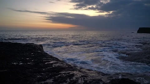 Dramatic ocean waves crashing on rocky coastline at sunset Stock-Footage 330717918