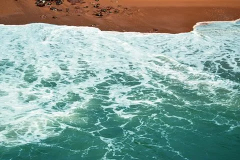 Dramatic Ocean Waves Splashing Against Rocky Shore Sandy Beach Landscape Stock Photos