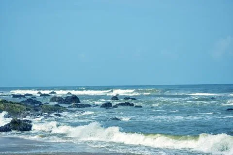 Dramatic Ocean Waves Splashing Against Rocky Shore Sandy Beach Landscape 스톡 사진