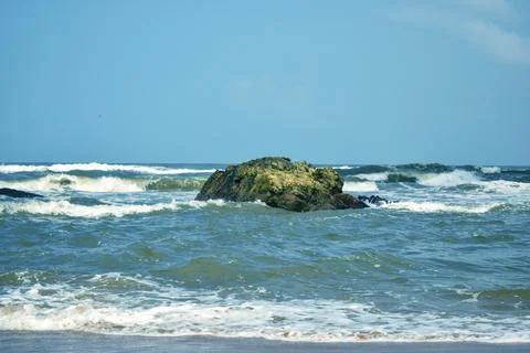 Dramatic Ocean Waves Splashing Against Rocky Shore Sandy Beach Landscape Stock Photos