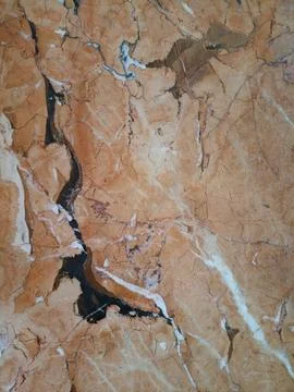 Dramatic orange breccia marble texture with sharp black veins Fotos Stock