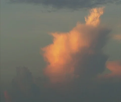 Dramatic orange cloud in bluish sky Stock Footage 86747679