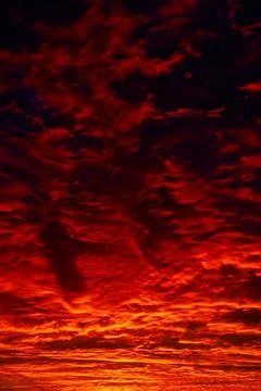 Dramatic orange clouds at sunrise or sunset vertical photo Stock Photos