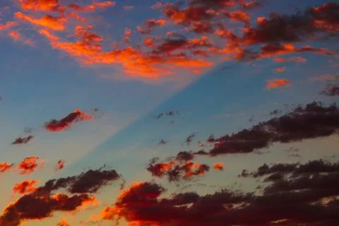 Dramatic orange clouds at sunset. Cloudscape abstract background photo. Stock Photos