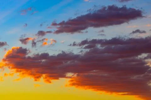 Dramatic orange clouds at sunset. Cloudscape abstract background photo. Stock Photos