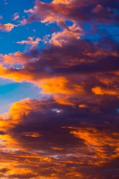 Dramatic orange clouds at sunset. Cloudscape abstract background photo. Stock Photos
