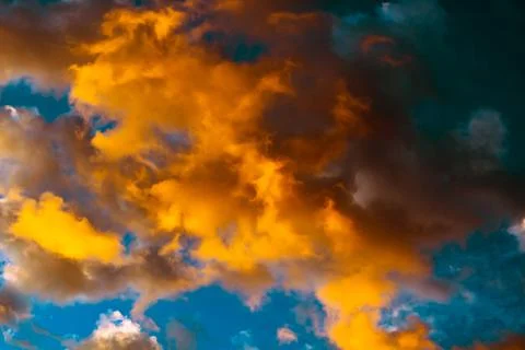 Dramatic orange clouds at sunset. Cloudscape abstract background photo. Stock Photos