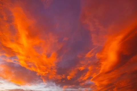 Dramatic orange clouds at sunset. Sunset cloudscape. Stock Photos