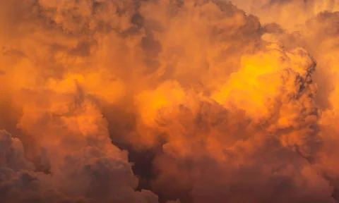 Dramatic orange sky and clouds abstract background. Top view of orange clouds 库存照片