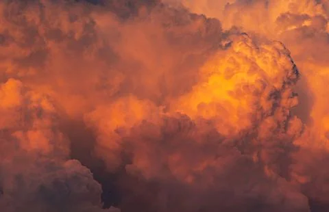 Dramatic orange sky and clouds abstract background. Top view of orange clou.. Photos
