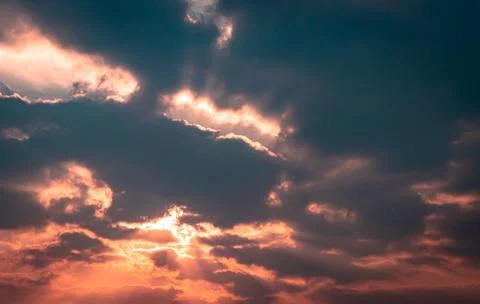 Dramatic orange sky with bleeding sun rays at dawn Stock Photos