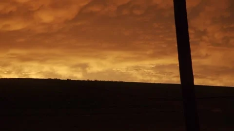 Dramatic Orange Sky Over Rolling Hills at Dusk Stock-Footage 336961161