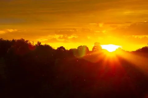 Dramatic orange sky on a warm autumn evening Stock Photos