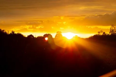 Dramatic orange sky on a warm autumn evening Stock Photos