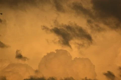 Dramatic Orange Storm Clouds at Sunset Background Stock Photos