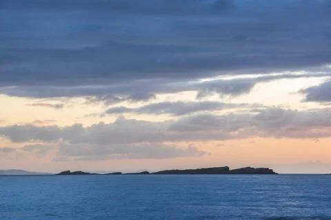 Dramatic orange sunset on the beautiful coastline of the Antrim Coast in Stock Photos