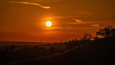 Dramatic Orange Sunset Lights up High Cloud Formations Stock Footage 281926538