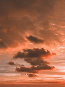 Dramatic Orange Sunset Sky with Dark Clouds Stock Photos