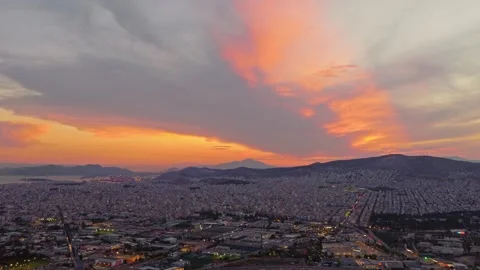 Dramatic orange sunset sky over athens cityscape at dusk Stock Footage 337728765