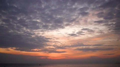 Dramatic orange sunset sky with purple fluffy peaceful clouds Stock Footage 168568003