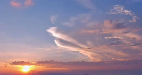 Dramatic orange sunset with the sun peeking through the clouds Stock Footage 200964018