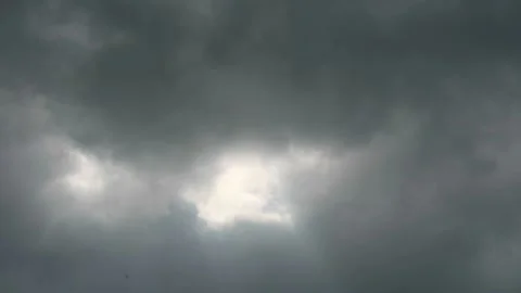 Dramatic Overcast Sky with Bright Light Peeking Through Dark Clouds and Moo.. Stock Footage 332700365