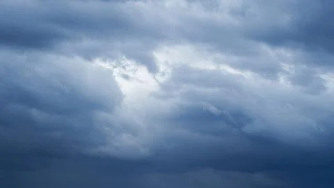 Dramatic overcast sky with dense dark blue clouds gathering before a rainstor Stock Photos