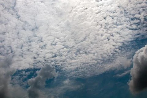 Dramatic overcast sky featuring layered cumulus and altocumulus fluffy clou.. Stock Photos