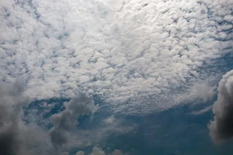 Dramatic overcast sky featuring layered cumulus and altocumulus fluffy clou.. Stock Photos