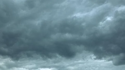 A Dramatic Overcast Sky Filled with Dark, Thick Clouds Enveloping the Serene Lan Stock Photos