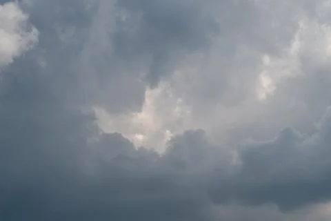 Dramatic overcast sky with light breaking through clouds Stock Photos