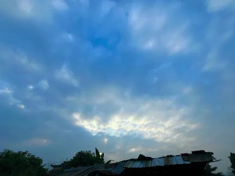 Dramatic Overcast Sky with Soft Golden Sunlight Breaking Through the Dark Clouds Stock Photos