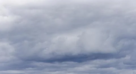 Dramatic overcast sky with thick storm clouds. Grey cloud cover fills the f.. 写真素材