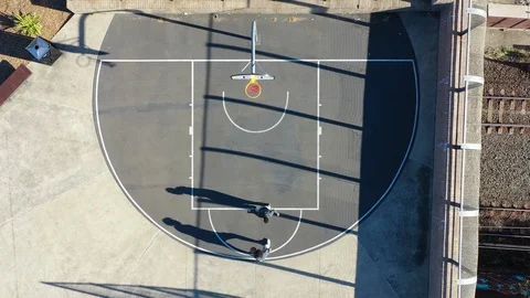 Dramatic Overhead Drone Shot of Two Basketball Players Stock Footage 118505002