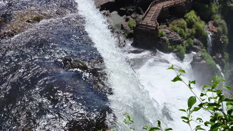 Dramatic overhead footage of a waterfall drop-off into a misty abyss 스톡 동영상 336676114