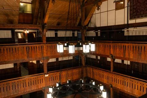 Dramatic overhead view of vintage wooden balconies and hanging lights. Stock Photos