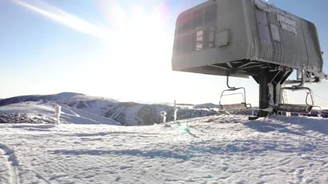 Dramatic Pan Beside Ice Covered Ski Lift Station on Sunny Morning Stock Footage 137881506