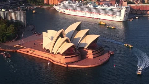 Dramatic pan up revealing the Sydney Opera House with a P&amp;O cruise ship in the Stock Footage 304417662