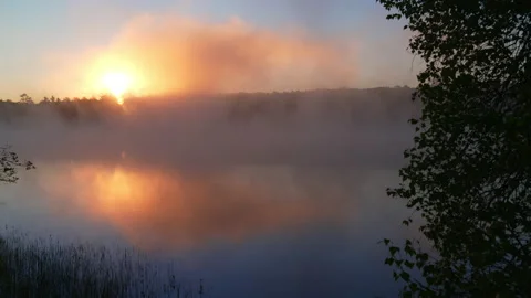 Dramatic pan of sunrise over river with fog. Stock Footage 144458452