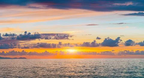 Dramatic panorama sea scape water background and sunset shine light in clouds Stock Photos