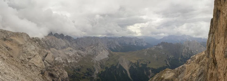 Dramatic panoramic view over rugged Dolomites peaks and deep alpine valleys.. Stock Photos