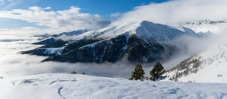 Dramatic panoramic winter mountain landscape with cloud inversion Stock Photos
