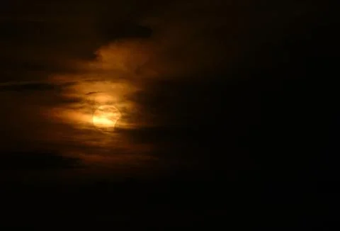 Dramatic Partial Solar Eclipse against cloudy sky from Italy. Stock Photos